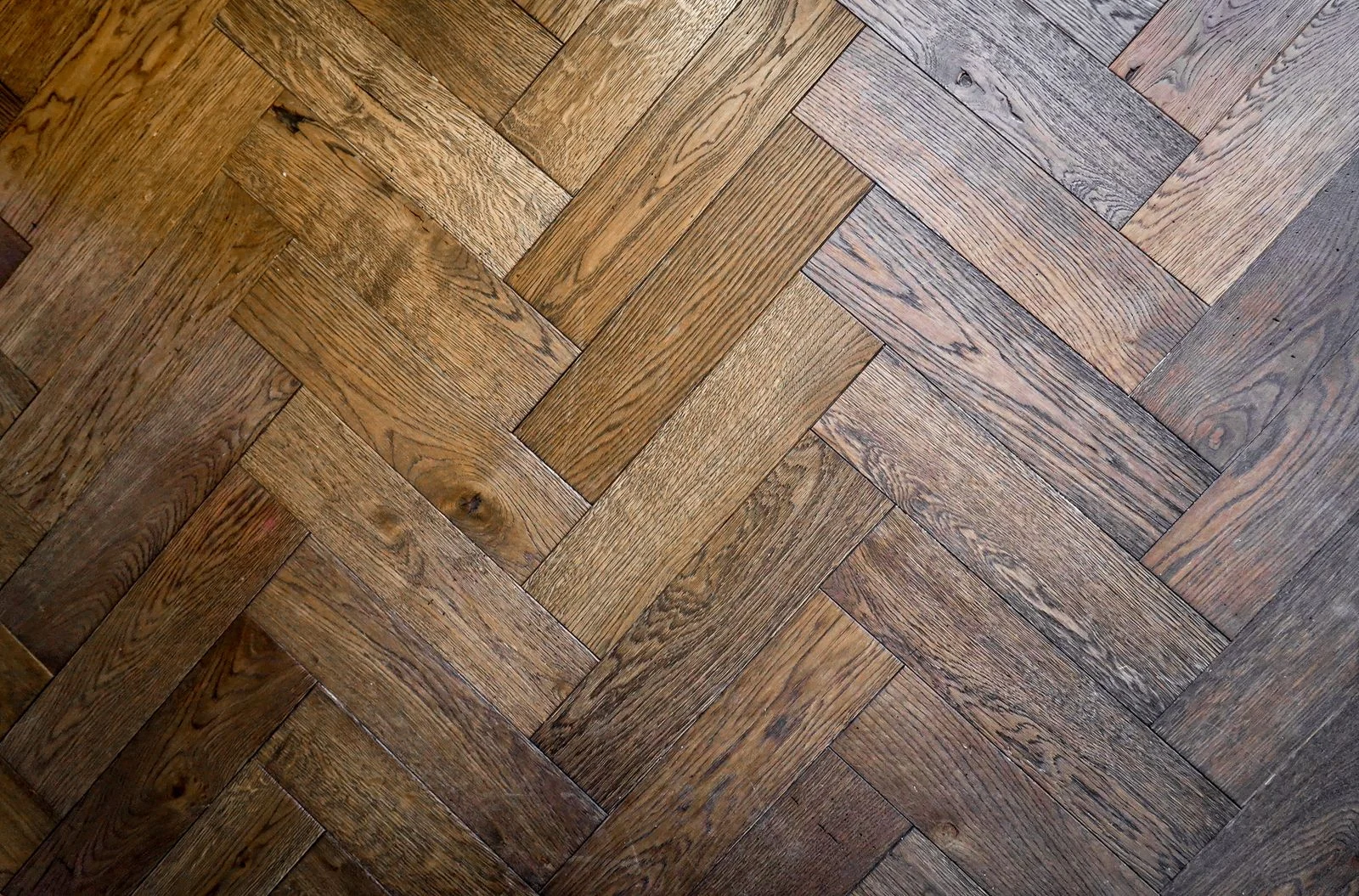 Herringbone wood floor in warm oak tones